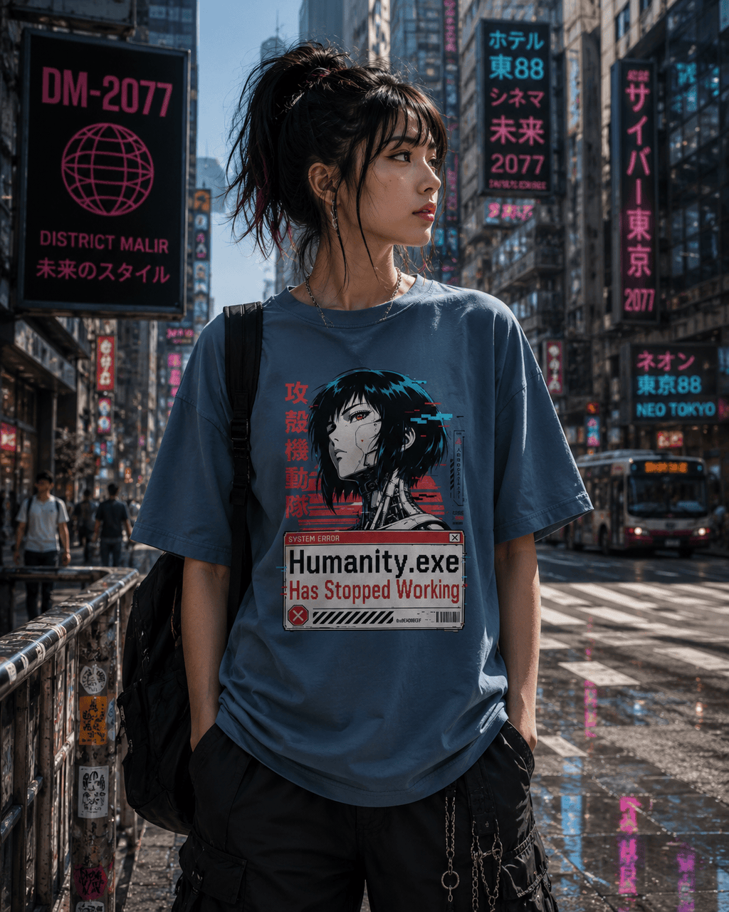 A woman stands on a city street wearing an oversized blue graphic T-shirt with a stylized anime-style portrait and the text 'Humanity.exe Has Stopped Working.