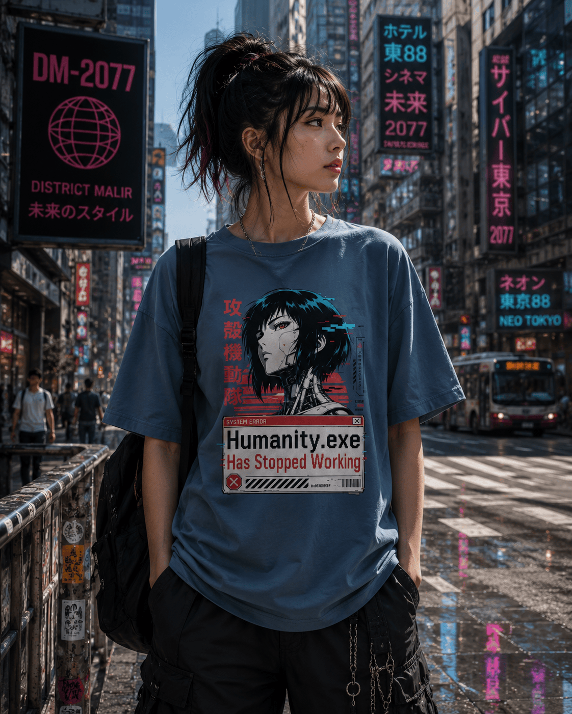 A woman stands on a city street wearing an oversized blue graphic T-shirt with a stylized anime-style portrait and the text 'Humanity.exe Has Stopped Working.