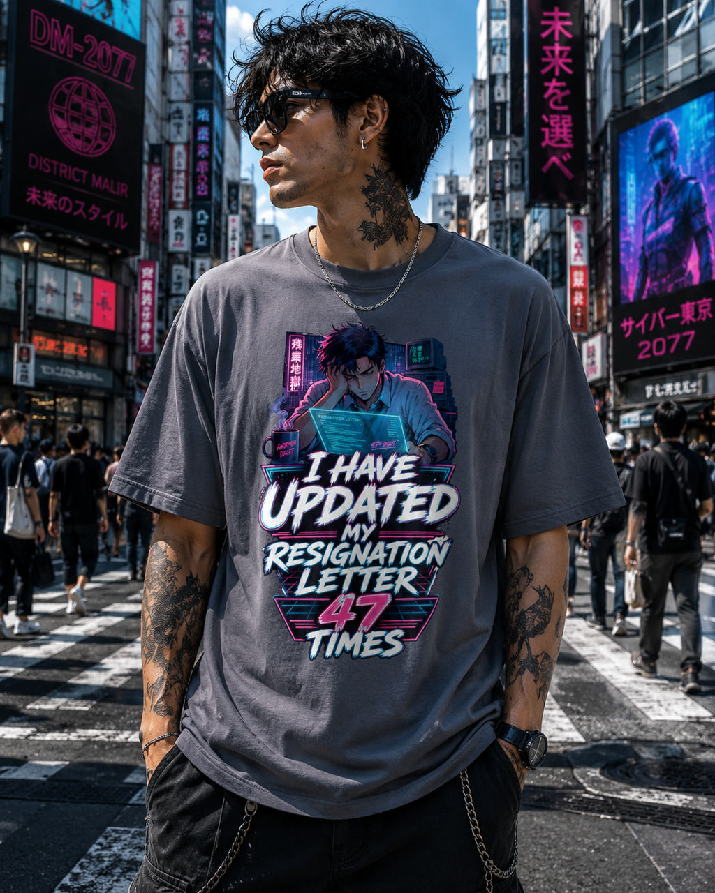 A man wearing a gray graphic t-shirt with a cyberpunk-style print and the text 'I HAVE UPDATED MY RESIGNATION LETTER 47 TIMES' stands in a busy city street in Tokyo, Japan, with neon signs in the background.