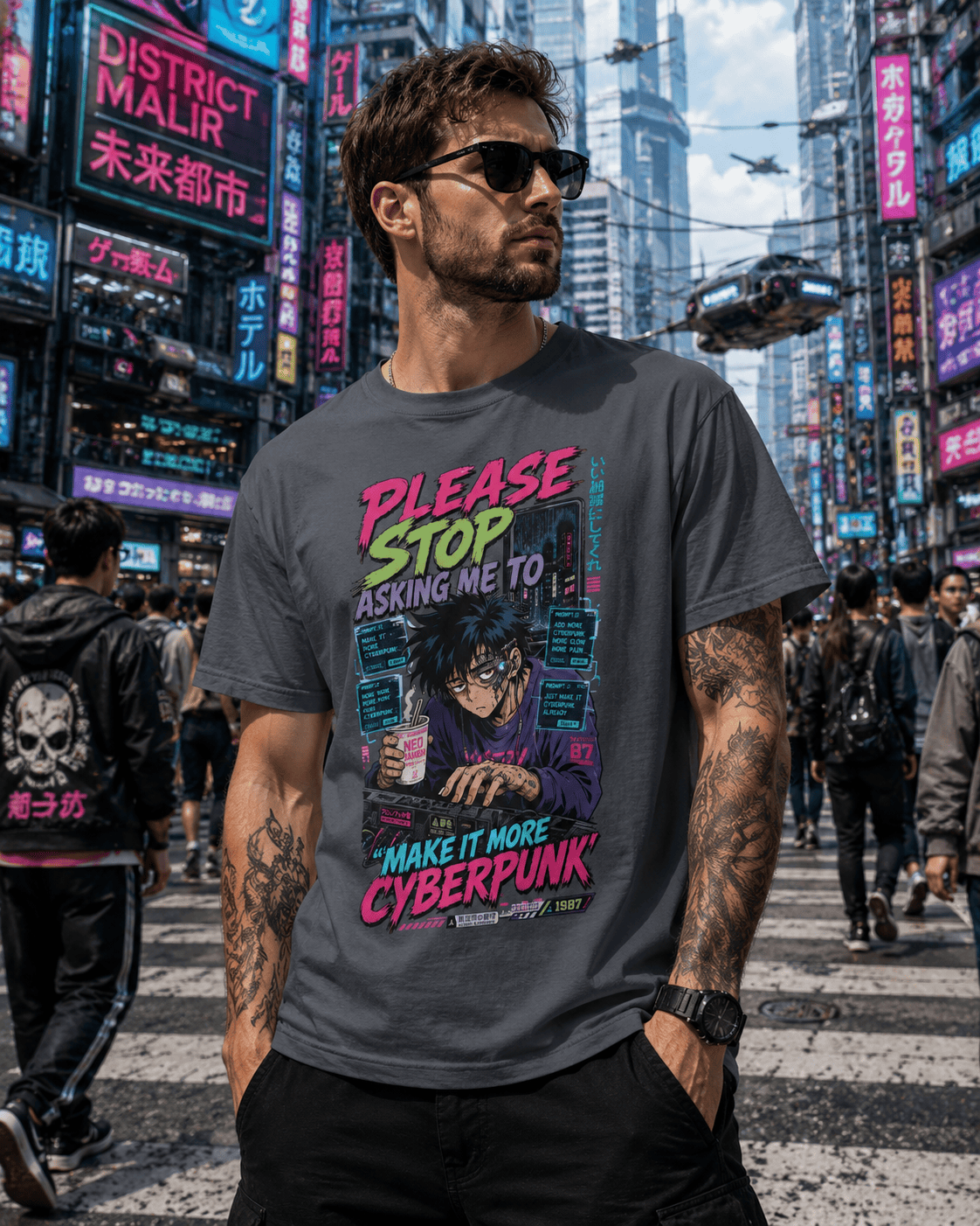 A man wearing a dark gray graphic t-shirt with a cyberpunk-themed print, standing in a busy neon-lit city street.